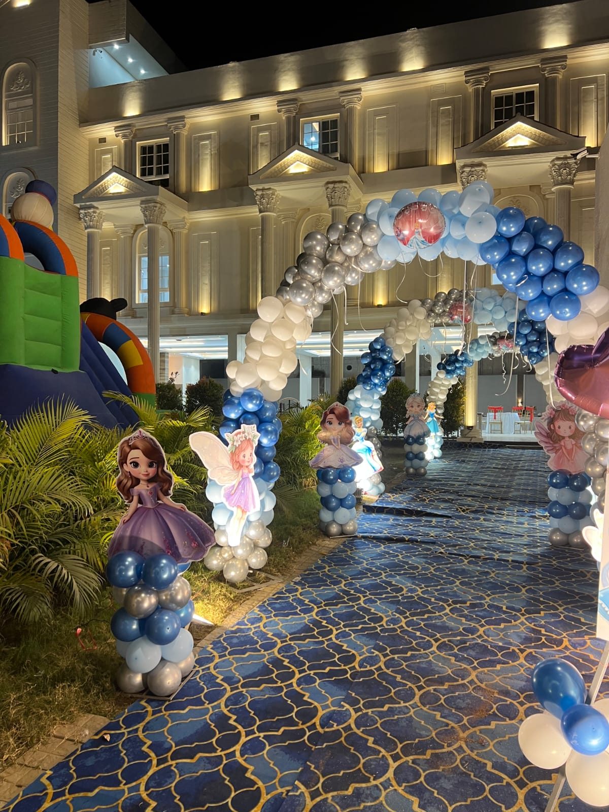 Balloon arch and character décor set up at the venue façade for a birthday