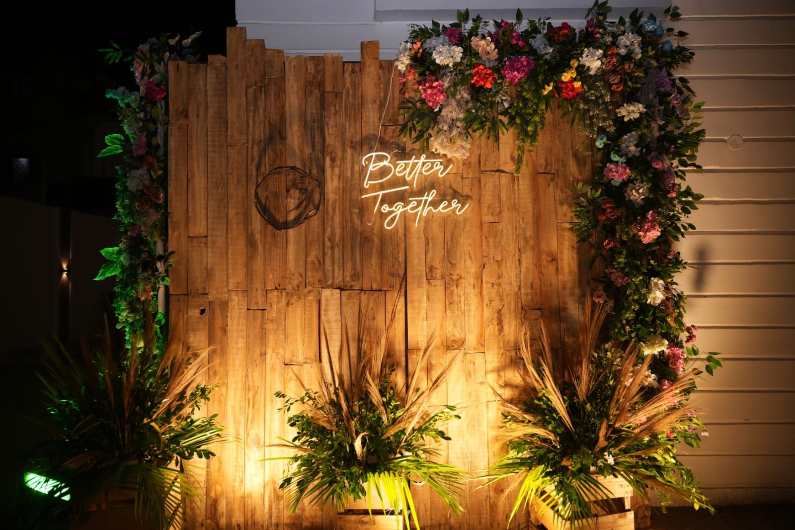 Rustic wooden Better Together backdrop with floral styling