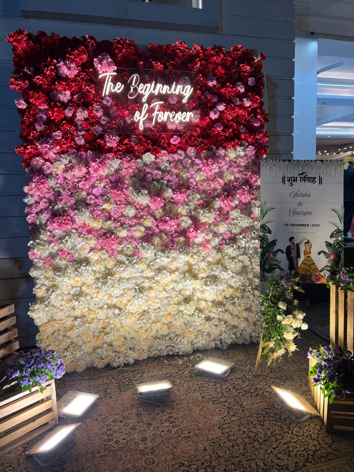 Pink and white floral wall reading The Beginning of Forever